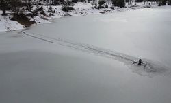 Bursa'da buz tutan gölün üzerinde önce çökertme oynadı, buzu kesip suya girdi