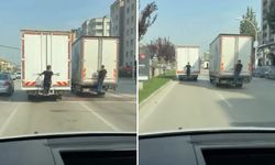 Bursa’da tehlikeli yolculuk kamerada! Kamyonların arkasına tutundular