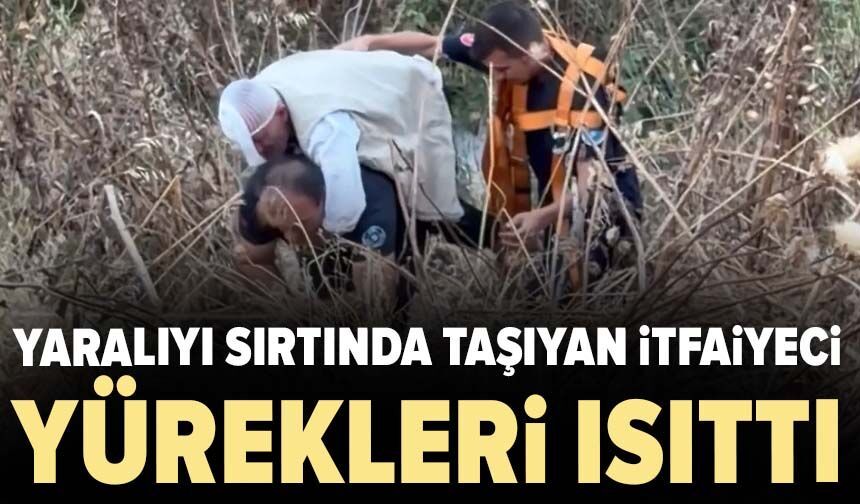 Yaralıyı sırtında taşıyan itfaiyeci yürekleri ısıttı